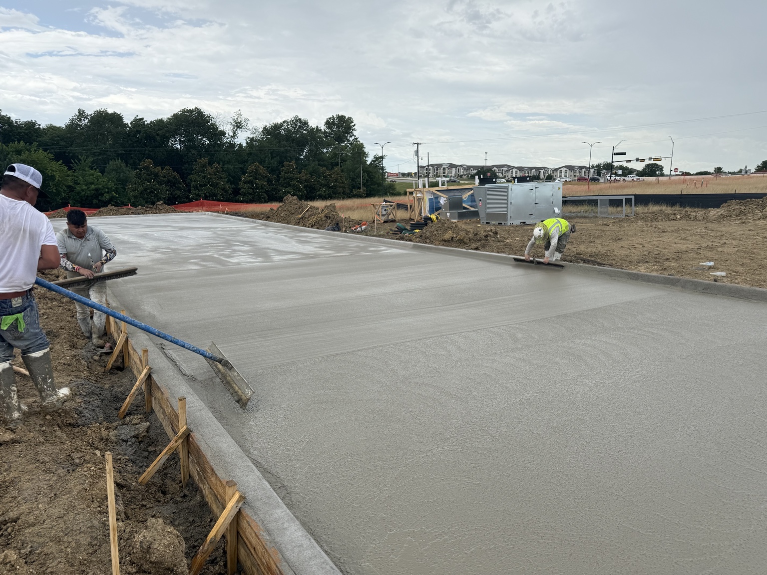 Concrete crew finishing a foundation placement